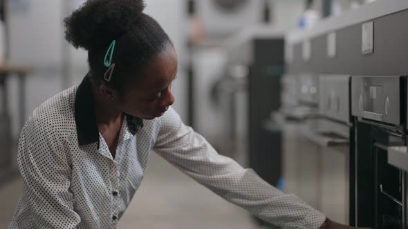 Black Woman is Choosing Electric Oven in Home Appliances Store Housewife is Comparing Exhibition