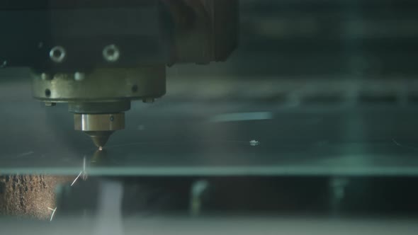 CNC Laser cutting a metal plate in a manufacturing facility