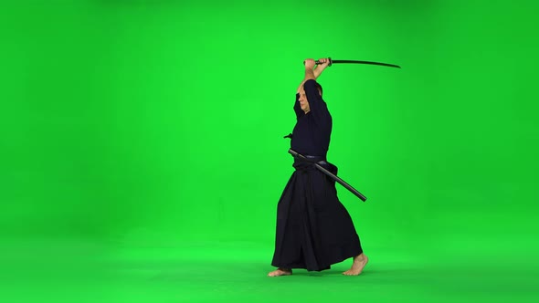 Masculine Kendo Warrior Practicing Martial Art with the Bamboo Bokken on Green Screen