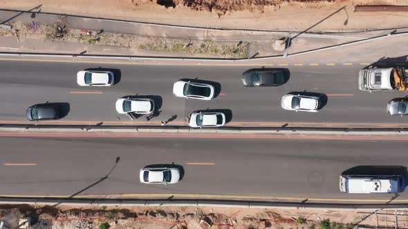 Car crash on a busy highway with smashed car and traffic passing by.