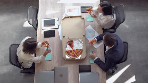 Employees Taking Slice of Pizza