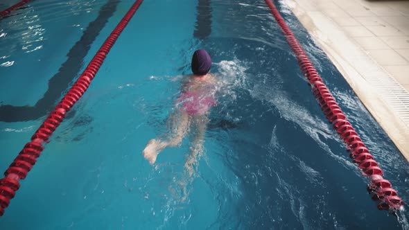 Girl Child in Swimming Pool. Smiling Child Leads a Healthy Lifestyle and Keen on Sports