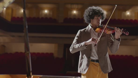 African American Violin Player Practicing in Music Hall