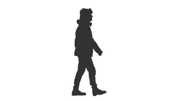 Silhouette of Man Walking in Down Jacket and Winter Hat