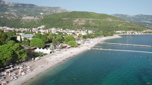 Aerial View Budva Beach By Sea with Sun Loungers and People Seashore Montenegro