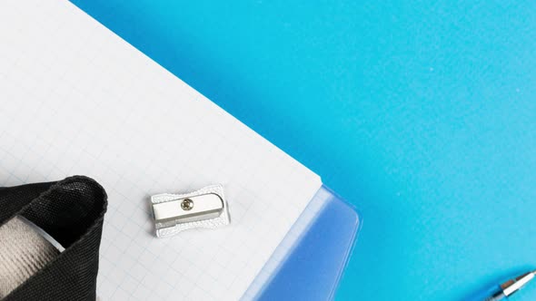 School Supplies Lie on a Pastel Blue Background Together with