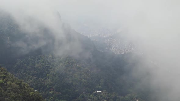 Thick Fog Enveloping Mountain Summit In A Cold Afternoon - aerial shot