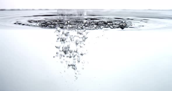 Water drips into a water surface - white background alt