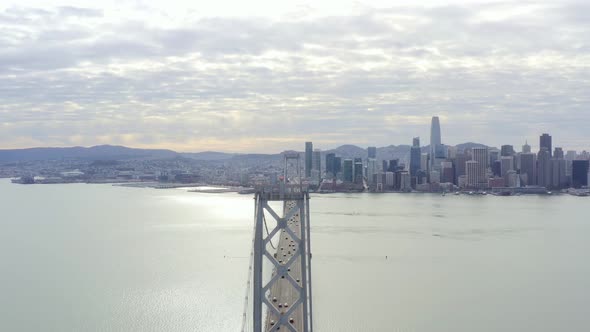 Aerial: cityscape and a bridge on the pacific ocean, drone view