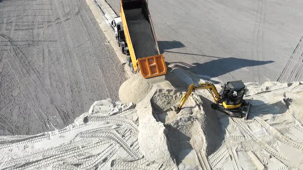 The Truck Pours Sand on the Site, Excavator Scooping Sand Bucket