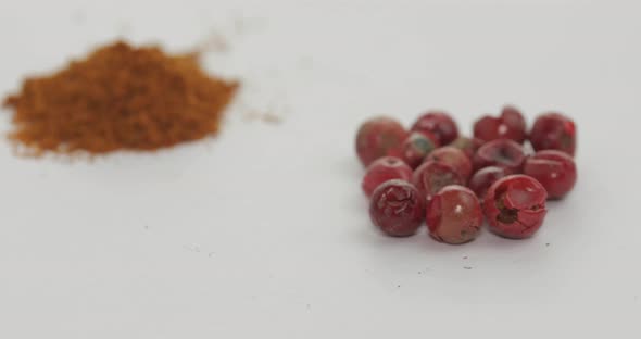 Red Pepper Powder Rotation. Macro Shot Against a White Background