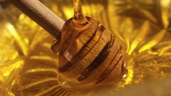 Liquid Honey Pouring on Honey Dipper