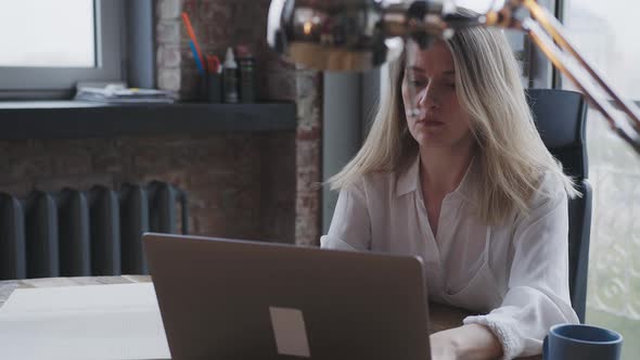 Young Woman Works for a Laptop in the Office Make the Business Correspondence