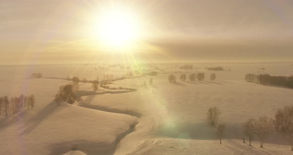 Aerial View of Cold Winter Landscape Arctic Field Trees Covered with Frost Snow Ice River and Sun