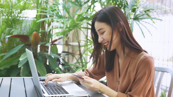 Woman Making Payment on Laptop with Card