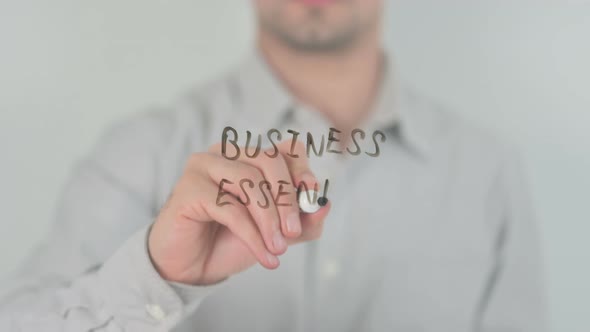 Business Essentials Writing on Screen with Hand