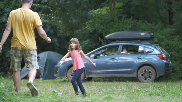 Young Father and His Child Daughter Having Fun Outdoors at Camping Site in Summer