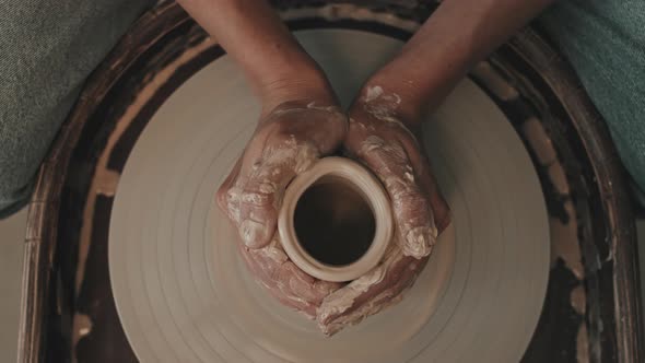 Hands Shaping Jar on Pottery Wheel