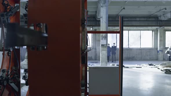 Closeup Robotic Tire Machine Moving at Modern Automotive Workhouse Facility