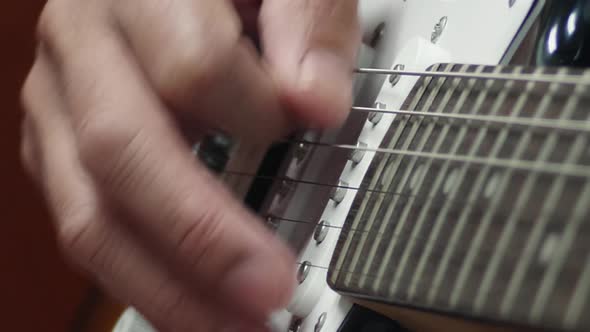 Closeup of a man practicing playing the guitar Spot focus has a beautiful scene