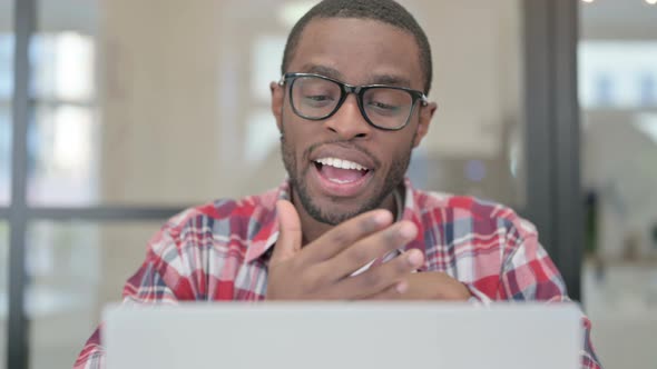 Close Up of African Man Talking on Video Chat on Laptop