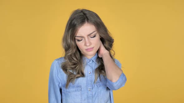 Young Girl with Neck Pain Yellow Background