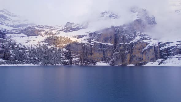 Oeschinensee Lake Switzerland Surrounded by Snow Covered Trees and Mountains