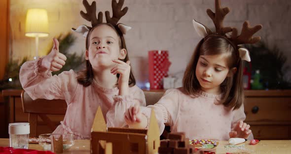 Two Cute Sisters Build Decorate Christmas Gingerbread House