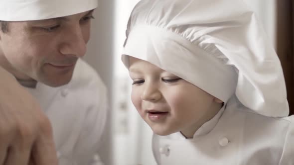 Lovely Closeup of Dad and Son Playing with Cake Batter