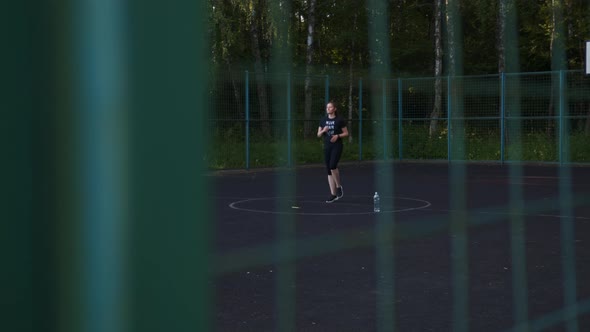 Woman Actively Runs in Place on the Basketball Court Morning Exercises