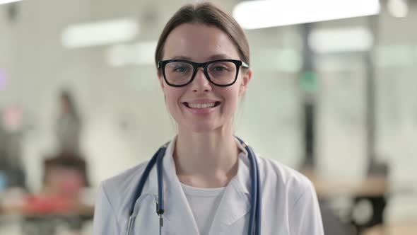 Portrait of Attractive Young Female Doctor Smiling at Camera 