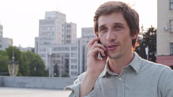 Smiling Millennial Man Talking Chatting on Phone Young Euphoric Happy Male Executive Employee