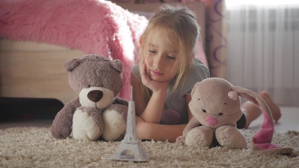Little Girl with Her Toys at Children Room Dreaming About Travel To Paris. Child Dream, Vacation and