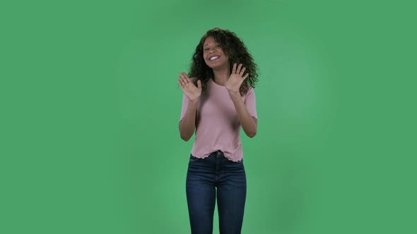 Portrait of Beautiful African American Young Woman Is Looking at Camera and Dancing Funny. Burning