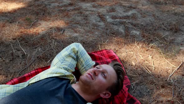 Couple lying on blanket in olive farm