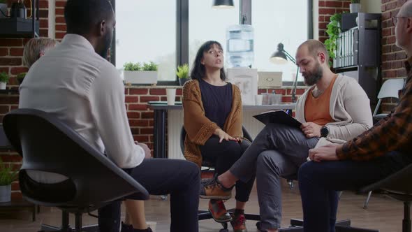 Woman with Nervous Behavior Sharing Mental Health Issues with People at Aa Group Therapy Session