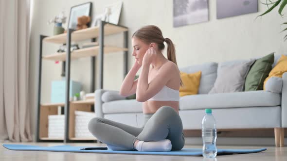 Young Woman Listening Music on Headphones and Meditating