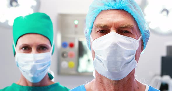 Portrait of surgeons wearing surgical mask in operation theater