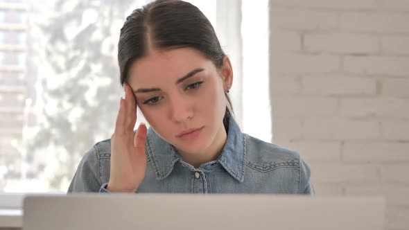 Close Up of Young Girl with Headache at Workplace