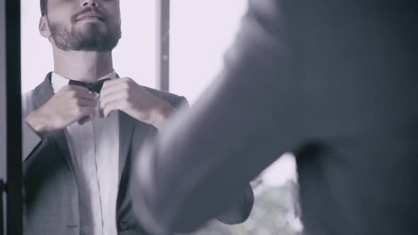 Man in Formal Suit Getting Dressed in Dressing Room for Work or Wedding