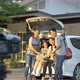 Happy family sit on the car and take a photo together - VideoHive Item for Sale
