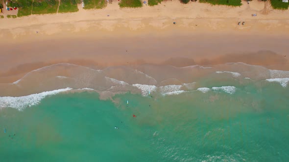 Top View of the Waves on a Tropical White Sand Beach and Surfers with Surfboards