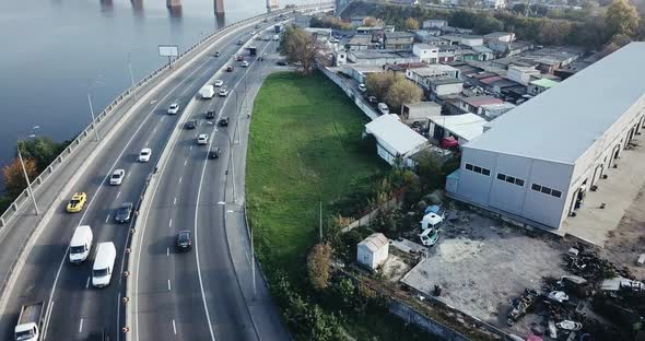 Flight Over the Highway Along the River and the Industrial Zone on the Other Side Against 