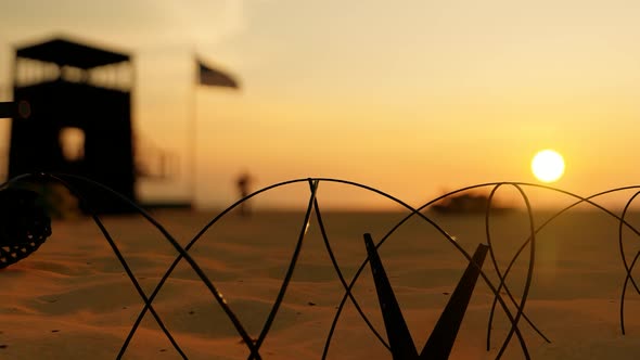 Border Area Barbed Wires and Sunset