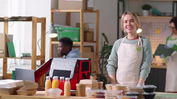 Portrait of Young Happy Woman at Work in Food Delivery Kitchen