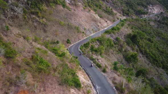 Aerial Over Motorists Traveling at Countryside Road on the Edge of the Mountain