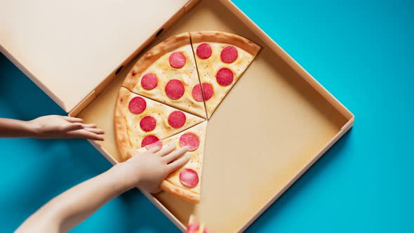 Aerial view of an opening pizza box while lunchtime.Hands taking slices of pizza