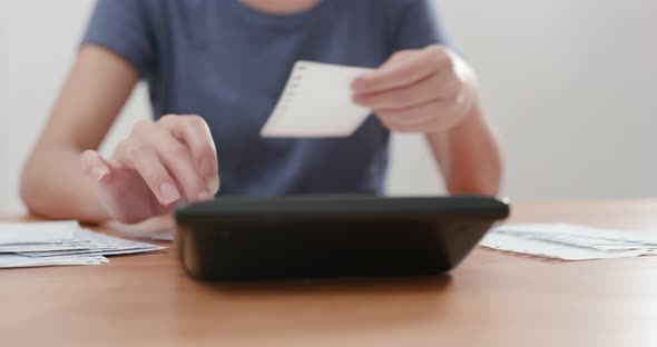 Housewife Woman use of calculator for daily expense