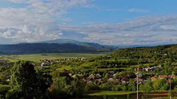 Lifestyle in the Carpathian Village on a Green Meadow in Mountains in the Houses Near Forest