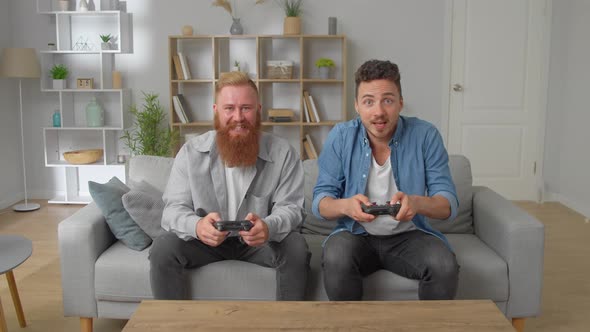 Caucasian Friends With Joystick Playing Video Games At Home